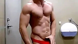 Hung bodybuilder flexing shirtless with reference to red horseshit sox briefs zak rogerz