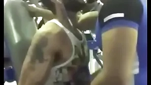 Elegant blithe kiss at gym between two indians